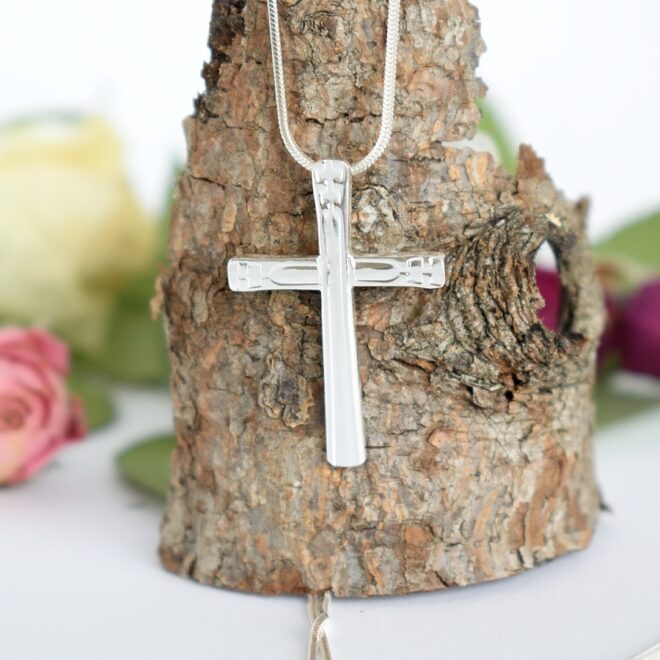 Voima-ristiriipus, joka on muotoiltu hopeisten lusikoiden varsista. Riipuksen koko on 30 x 20 mm ja Sterling-hopeisen käärmeriipusketjun pituus on 50 cm.