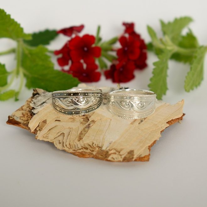 Kuvassa kaksi hopeasormusta, joista toinen on tummennettu ja toinen kiiltävä.